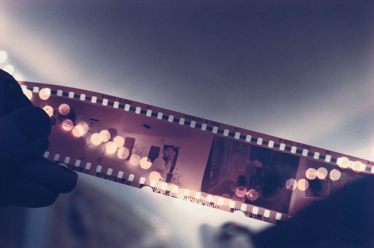 Closeup of a short length of photographic film held up to the light for inspection